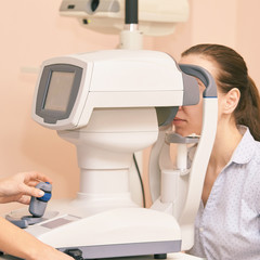 ophthalmologist doctor in exam optician laboratory with female patient. Eye care medical...