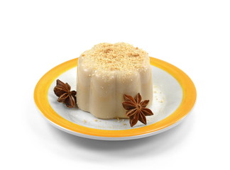 Hazelnut caramel pudding sprinkled with ground biscuits isolated on white background.