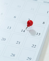 Calendar and red pushpin on 14 February