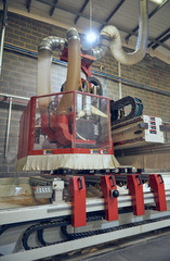 Industrial automated robot machinery in an industrial workshop factory environment. Automated machinery taking jobs away from humans. Machines versus humans. mass production for corporate profits.