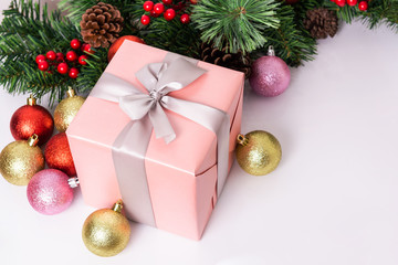 Fototapeta na wymiar Beautiful pink gift box with Christmas ornaments on white background