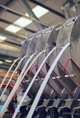 Industrial automated robot machinery in an industrial workshop factory environment. Automated machinery taking jobs away from humans. Machines versus humans. mass production for corporate profits.