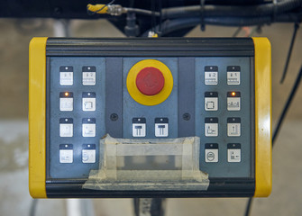 automated industrial factory control desk screens and buttons overseeing the automated machinery where humans are no longer needed. computers and robot controls making more money for corporations.
