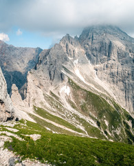 Beatiful view on Jubilaumsgrat via ferrata in Slovenia between Prisojnik and Triglav, meadow in mountain saddle, view on Razor mouintain