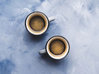 Two coffee cups on sky blue background. Minimal flat lay. Love concept