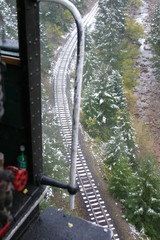Stem locomotive and rail tracks on a rainy, snowy day