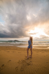 Blonde model on the beach at sunset