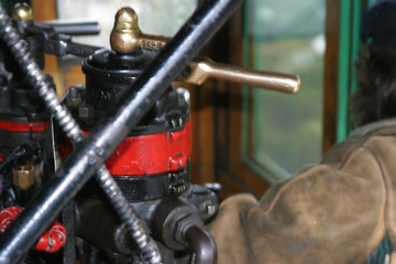 Steam locomotive details on a rainy, snowy day