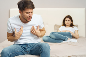 couple sitting on sofa and watching tv