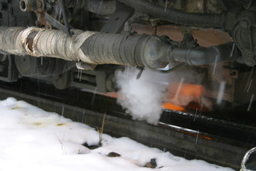 Steam locomotive details on a rainy, snowy day
