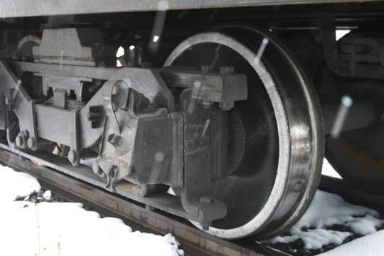 Steam locomotive details on a rainy, snowy day