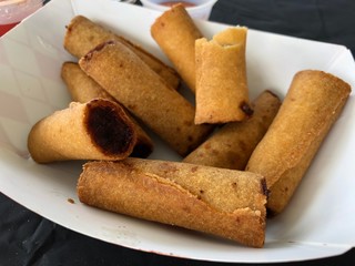 Close up of a serving of vegetable rolls served in a white bowl