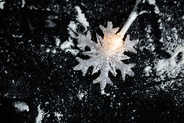 Snowflake Christmas lights on black background.