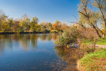 Fototapeta na wymiar Autumnal landscape with small Ukrainian river Oril at sunny day