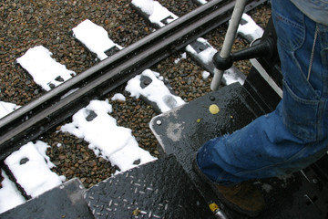 Steam locomotive details on a rainy, snowy day