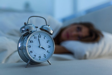 Sleepless and desperate beautiful caucasian woman awake at night not able to sleep, feeling...