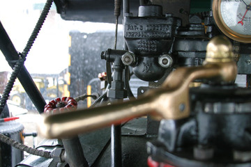 Steam locomotive details on a rainy, snowy day