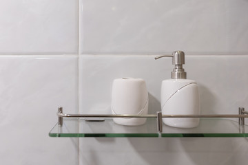 Beauty products in bottles accessories dispenser bathroom interior