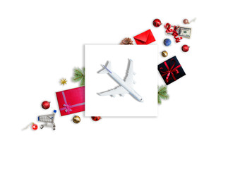 Christmas travel planning. Traveling as gift. White blank model of passenger plane and gift box on background. Top view or flat lay. Copy Space.