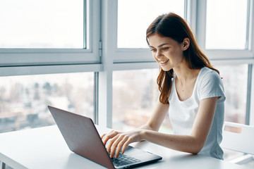 young woman working on her laptop at home