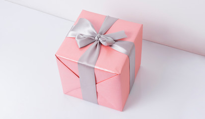 Pink presents with silk ribbon on white background