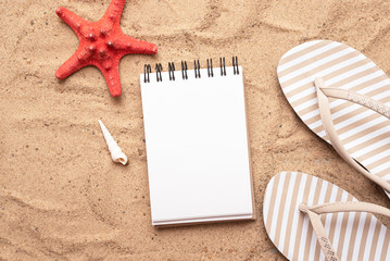 Notepad on the sand flat lay background. Sea vacation diary mockup. Summer to do list template.