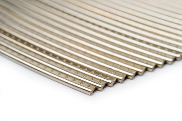 Frets of the guitar neck metal, workpieces for manufacturing, shot large on a white background
