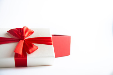 Beautiful Christmas gift box with red ribbon on isolated background. Happy New Year and merry christmas.