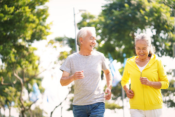 senior asian couple running in park