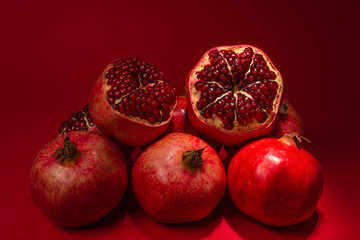 Sweet pomegranate on red background.