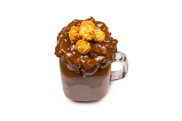 Chocolate milkshake with whipped cream, cookies, waffles, served in glass mason jar. 