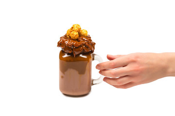 Chocolate milkshake with whipped cream, cookies, waffles, served in glass mason jar. 