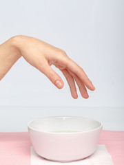 process manicure on fingernails from a professional manicurist in a salon or spa, close up top view