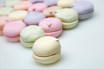 Fototapeta na wymiar Delicious multi-colored marshmallows on a white background