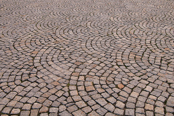 Texture of paved stone lined in a semicircle.