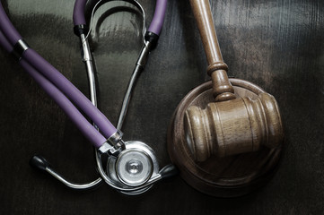 Judge gavel and stethoscope close up, malpractice concept