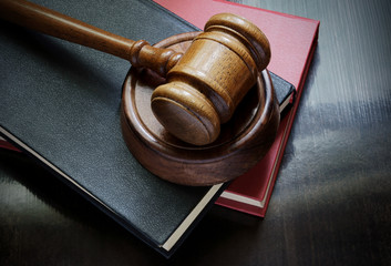 Judge gavel and legal books on wooden table