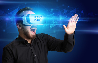 Businessman looking through Virtual Reality glasses with PRIVACY POLICY inscription, cyber security concept