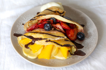 Crepes with Fresh Berries, Chocolate Sauce and Powdered sugar