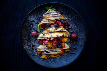 Crepes with Fresh Berries, Chocolate Sauce and Powdered sugar