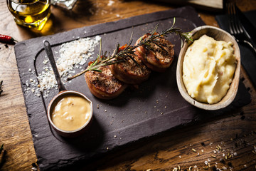 Pork tenderloin served on a board in restaurant
