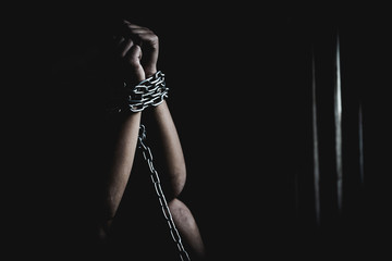 Child hands tied up with chain , human trafficking, Violence against children, Human rights violations concept