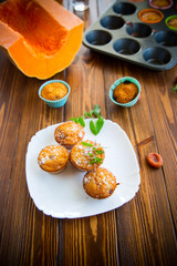 baked sweet pumpkin muffins with dried apricots inside,
