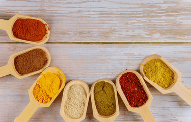 Assortment of spices and herbs in the wooden scoops.