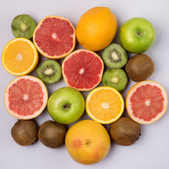 Tropical Fruits on Blue Background Ripe Kiwi Oranges Grapefruits Geen Apples Healthy Food Vitamin Diet or Detox Concept Flat Lay Top View Square