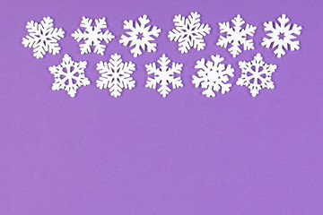Fototapeta na wymiar Set of white snowflakes on colorful background. Top view of Christmas ornament. New Year time concept with empty space for your design