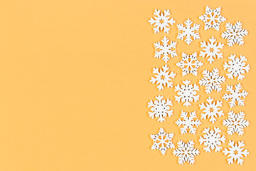 Top view of winter ornament made of white snowflakes on colorful background. Happy New Year concept with copy space