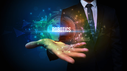 Elegant hand holding ROBOTICS inscription, digital technology concept