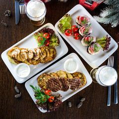 Christmas dinner, a table with festive dishes, food in plates on the table