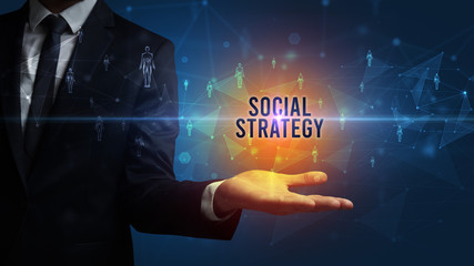 Naklejka premium Elegant hand holding SOCIAL STRATEGY inscription, social networking concept